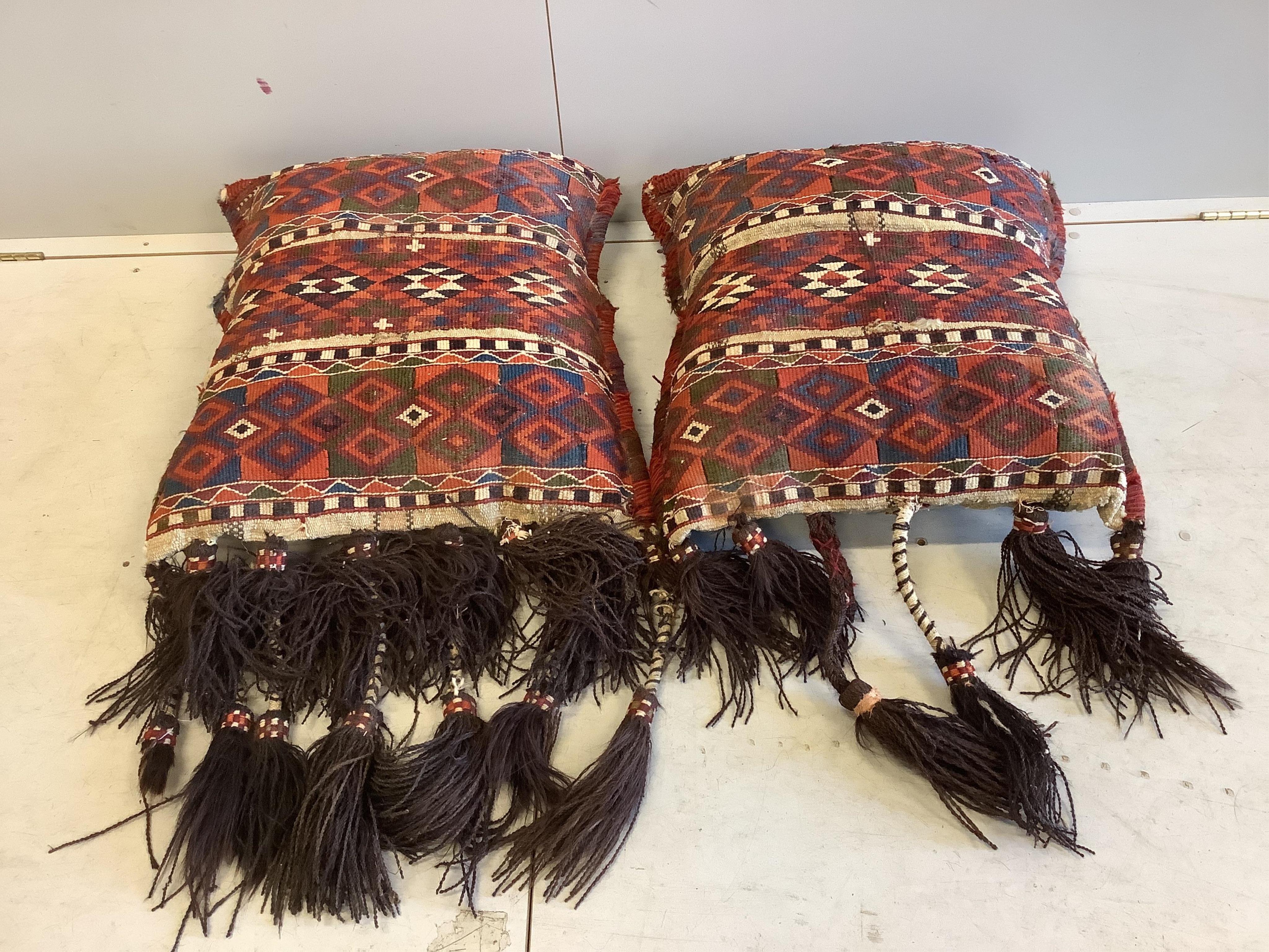 Two Kilim polychrome camel bags, now as cushions, each 65 x 60cm. Condition - fair